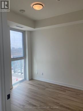 Oakville (Jm Joshua Meadows) condo for rent - A room with a sliding glass door and wood flooring.