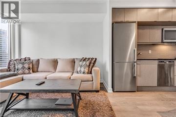 Toronto condo for rent - A modern living room with a grey sofa and a coffee table.