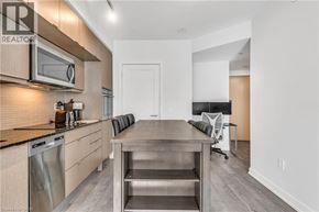 Toronto condo for rent - A modern kitchen with a wooden countertop and stainless steel appliances.