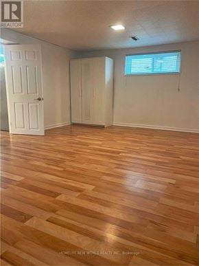 Richmond Hill (Crosby) apartment for rent - A room with wooden flooring and two white doors.