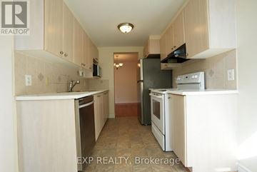 Ottawa townhouse for rent - A kitchen with white cabinets and appliances.