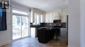 Toronto (Oakwood Village) apartment for rent - A kitchen with a black countertop and white cabinets.