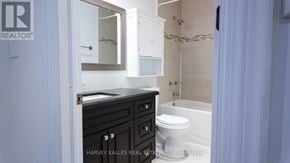 Toronto (Oakwood Village) apartment for rent - A bathroom with a toilet, sink and a mirror.