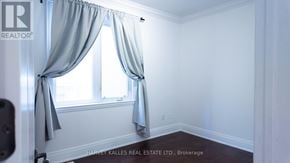 Toronto (Oakwood Village) apartment for rent - A room with a window and curtains, with a logo that reads REALTOR.