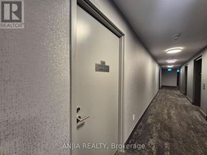Toronto (Tam O'shanter-Sullivan) condo for rent - A hallway with a door at the end and a sign that says "Brokerage".