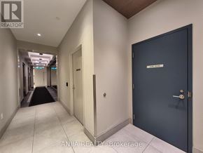 Toronto (Tam O'shanter-Sullivan) condo for rent - A hallway with a blue door and a sign that says "OFFICE".