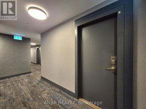 Toronto (Tam O'shanter-Sullivan) condo for rent - A hallway with a door on the right and a sign on the wall.