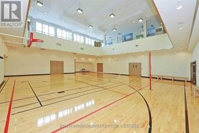 Mississauga (City Centre) condo for rent - A basketball court with a wooden floor and a basketball hoop.