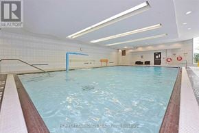 Mississauga (City Centre) condo for rent - A large indoor swimming pool with a blue starting block.