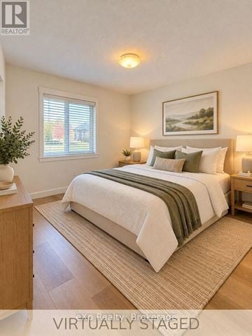 North Perth (Listowel) townhouse for rent - A bedroom with a bed, nightstands, and a painting on the wall.