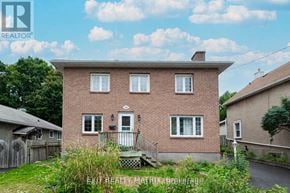 Ottawa apartment for rent - A house with a brick facade and a white door is for sale.