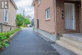 Ottawa apartment for rent - A residential street with houses on both sides and a car parked on the side of the road.