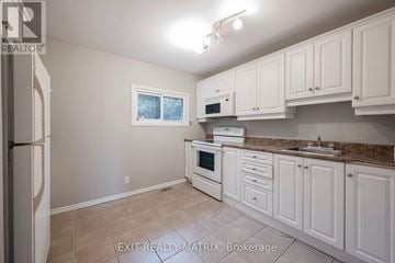 Ottawa apartment for rent - A kitchen with white cabinets and appliances.