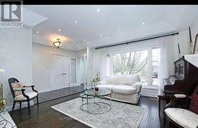 Richmond Hill (Mill Pond) apartment for rent - A well-lit living room with a glass coffee table and a white sofa.