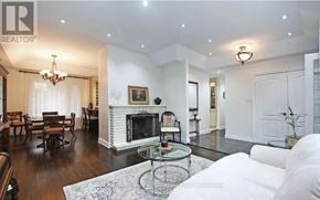 Richmond Hill (Mill Pond) apartment for rent - A living room with a fireplace and a glass table.