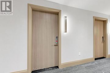 Vaughan (Vaughan Corporate Centre) condo for rent - A hallway with two doors and a carpeted floor.