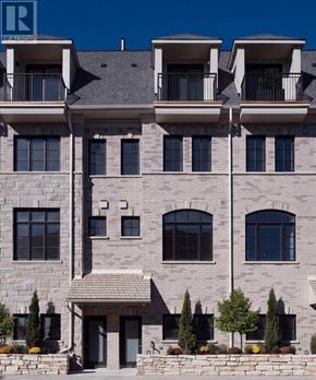 Toronto (Rockcliffe-Smythe) townhouse for rent - A large, modern building with a balcony on the second floor.