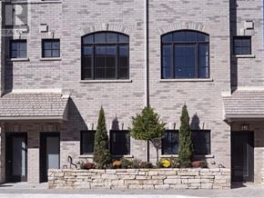 Toronto (Rockcliffe-Smythe) townhouse for rent - A stone building with a sign that says REALTOR on it.