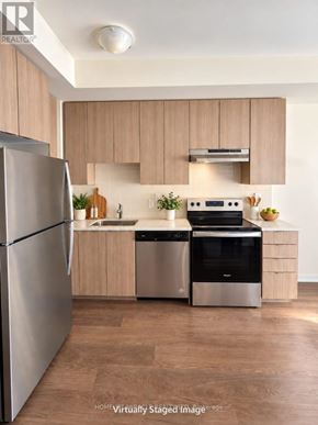 Toronto (Malvern) condo for rent - A modern kitchen with wooden cabinets and stainless steel appliances.