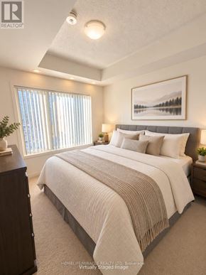 Toronto (Malvern) condo for rent - A bedroom with a large bed and a painting on the wall.