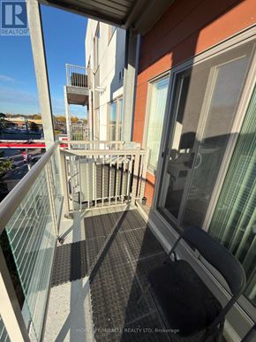 Toronto (Malvern) condo for rent - A balcony with a glass railing and a black chair.