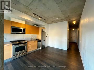 Toronto (Moss Park) condo for rent - A kitchen with a stove top oven and microwave built into a counter.