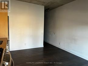 Toronto (Moss Park) condo for rent - A room with wooden floors and white walls, with a logo for HomeLife Landmark Realty Inc. in Brokerage.