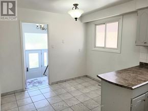 Brampton (Brampton North) apartment for rent - A kitchen with a marble countertop and a door leading to a balcony.