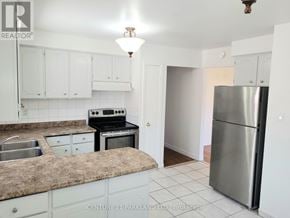 Brampton (Brampton North) apartment for rent - A kitchen with a granite countertop and stainless steel appliances.