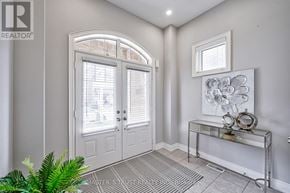 Burlington (Alton) apartment for rent - A white door with a glass window is in a room with a table and a plant.