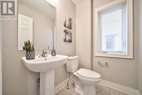 Burlington (Alton) apartment for rent - A white sink and toilet in a bathroom with a window.