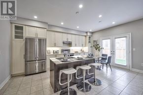 Burlington (Alton) apartment for rent - A kitchen with a refrigerator, stove, and bar stools.