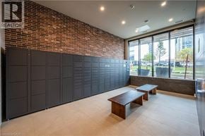 Kitchener condo for rent - A room with a brick wall and a sliding door.