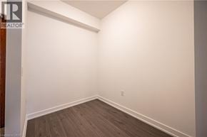 Kitchener condo for rent - A room with wooden flooring and white walls.