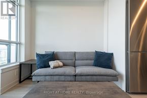 Vaughan (Brownridge) condo for rent - A grey couch with a striped throw blanket on it.