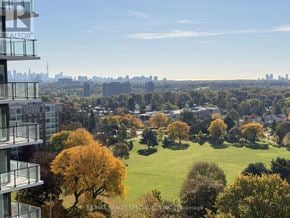 Toronto (Humber Heights) condo for rent - A view of a city from a high-rise building with a green park in the foreground.
