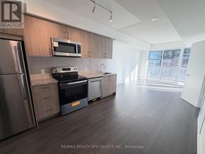 Toronto (Humber Heights) condo for rent - A kitchen with a refrigerator, microwave, oven, and dishwasher.