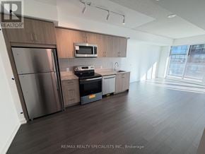 Toronto (Humber Heights) condo for rent - A kitchen with a stainless steel refrigerator and microwave above the stove.