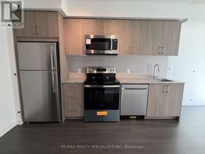 Toronto (Humber Heights) condo for rent - A modern kitchen with a refrigerator, microwave, oven, and sink.