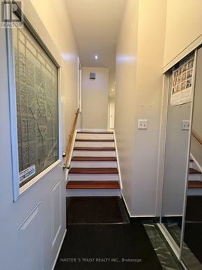Toronto (Hillcrest Village) apartment for rent - A hallway with a staircase and a door on the right.