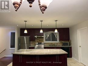 Toronto (Hillcrest Village) apartment for rent - A kitchen with a marble island and pendant lights.