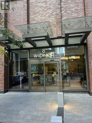 Toronto (Waterfront Communities) condo for rent - A kitchen with white cabinets and a microwave above the stove.