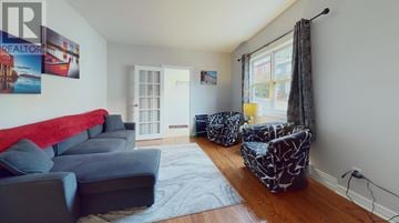 St. John's apartment for rent - A living room with a grey couch and a red cushion.