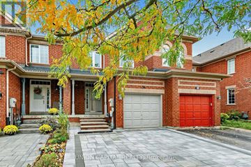 Vaughan (Maple) townhouse for rent - A brick house with a red garage door and a white door.