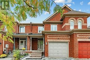 Vaughan (Maple) townhouse for rent - A red brick house with a white garage door.