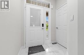 Vaughan (Maple) townhouse for rent - A white door with a glass window is in a hallway.