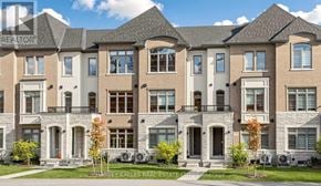Vaughan (Vellore Village) townhouse for rent - A row of townhouses with a sign that says "HARVEY KALLES REAL ESTATE".