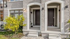 Vaughan (Vellore Village) townhouse for rent - A house with a grey facade and a tree with yellow leaves in front.