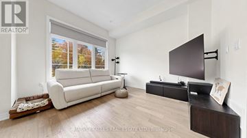 Vaughan (Vellore Village) townhouse for rent - A living room with a white couch and a flat screen TV.