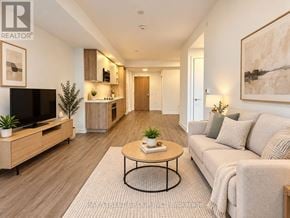 Vaughan (Vaughan Corporate Centre) condo for rent - A living room with a couch, a coffee table, and a television.
